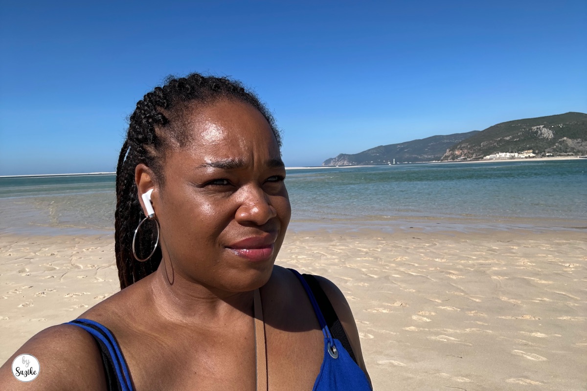 Suzike on the beach with blue sea and Arrabida views during a relaxing vacation in Troia Portugal
