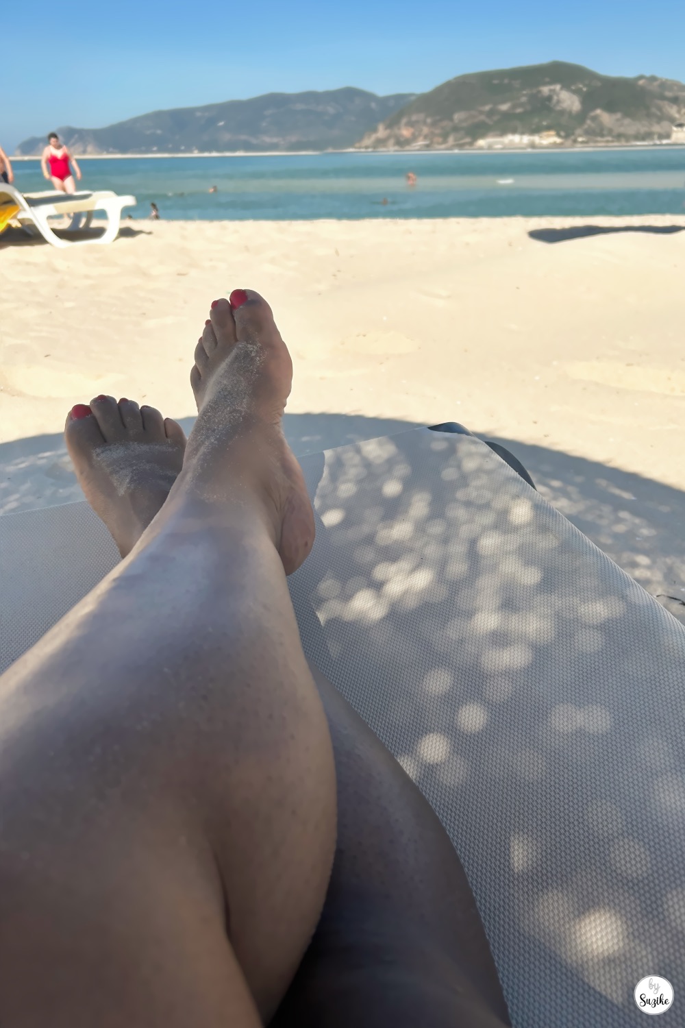 Relaxing beach lounger view with sandy beach and sea in Troia Portugal