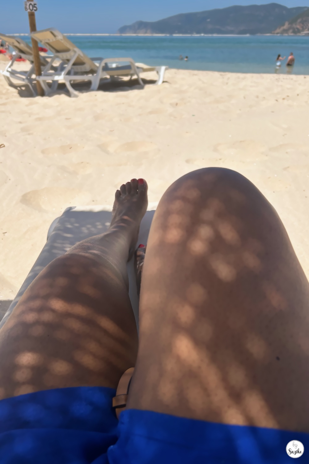 Beach lounger view under the sun with sea and sand during a relaxing vacation in Troia Portugal
