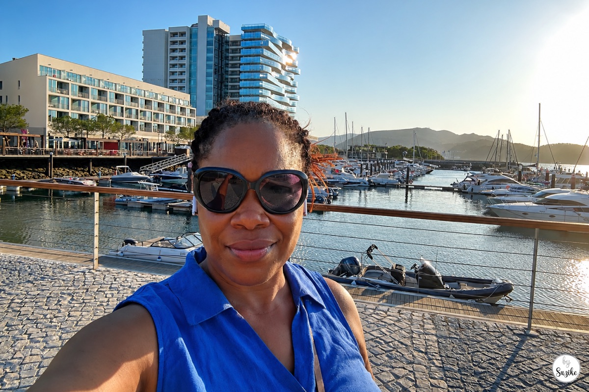 Suzike smiling by the marina during a relaxing vacation in Troia Portugal