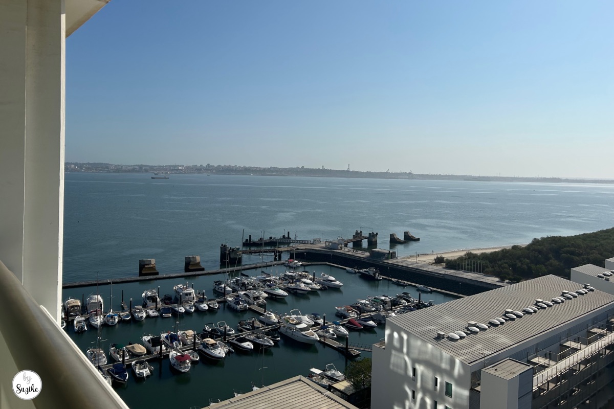 Hotel balcony view over the marina and sea during a relaxing vacation in Troia Portugal
