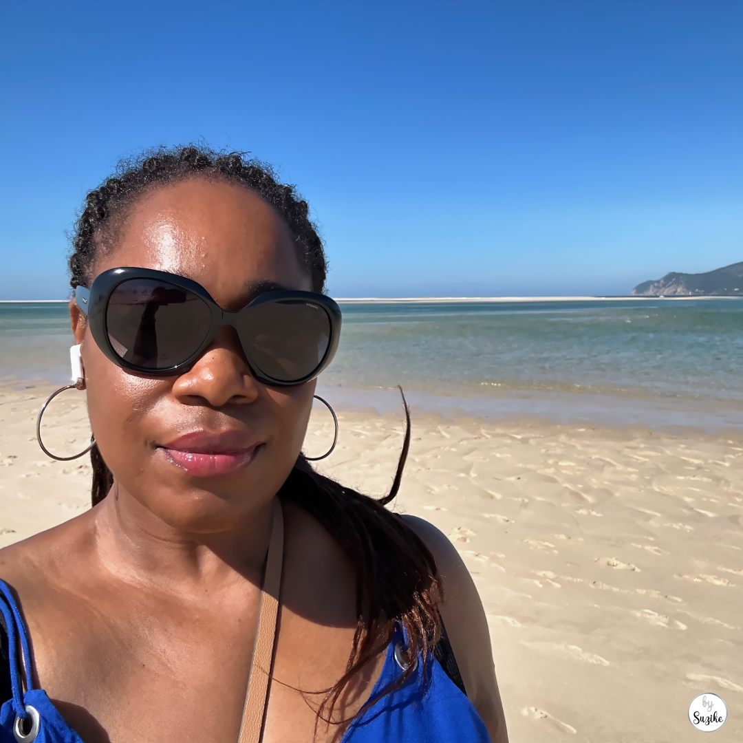 Suzike wearing sunglasses on a sunny beach in Troia Portugal