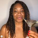 A woman drinking a martini while watching Mad Max: Fury Road, reflecting on a disappointing relationship.