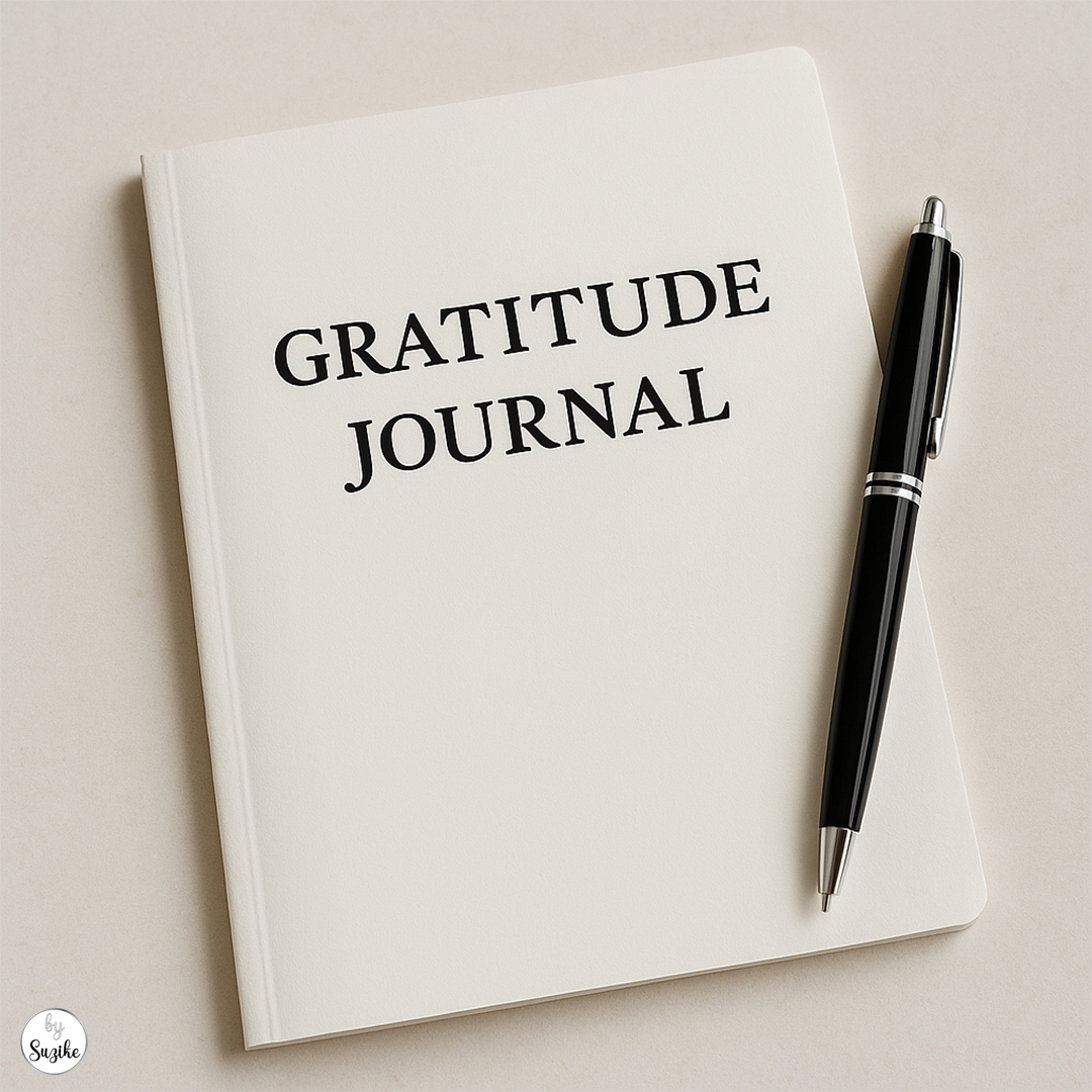 self-care for women_Close-up of a white gratitude journal and a black pen on a beige surface.