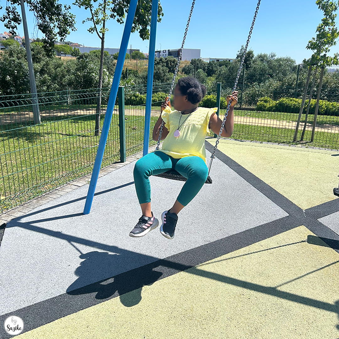 Little girl on a swing at the park, just before deciding to leave after a few minutes.
