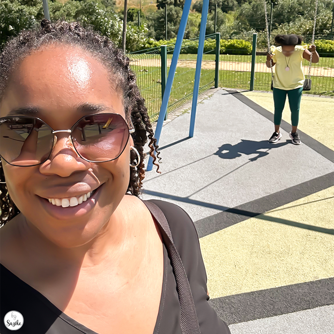 Mom and daughter taking a selfie at the park during a short day out.