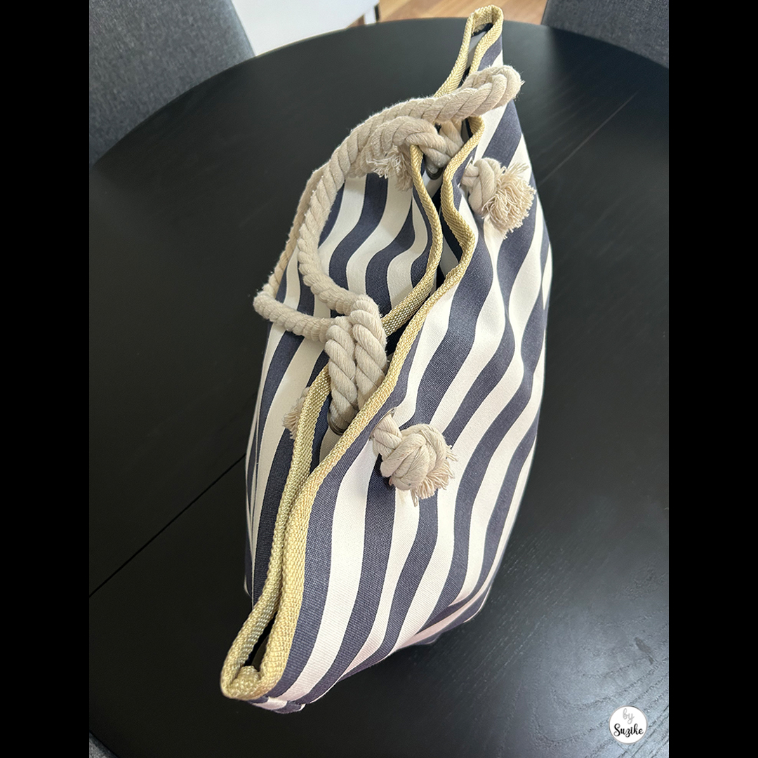 Top view of open navy and white striped beach bag, showing capacity and rope details – ideal beach bag for moms