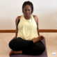 Suzike practicing yoga at home during her real-life fitness journey