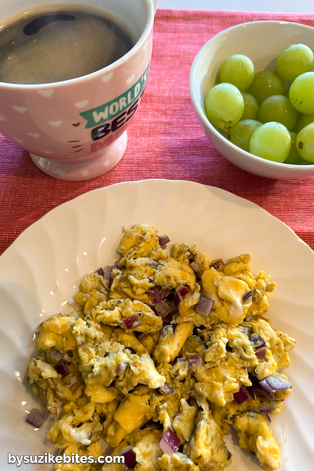 Day 7 breakfast of my weight loss journey: scrambled eggs with red onion, green grapes and black coffee