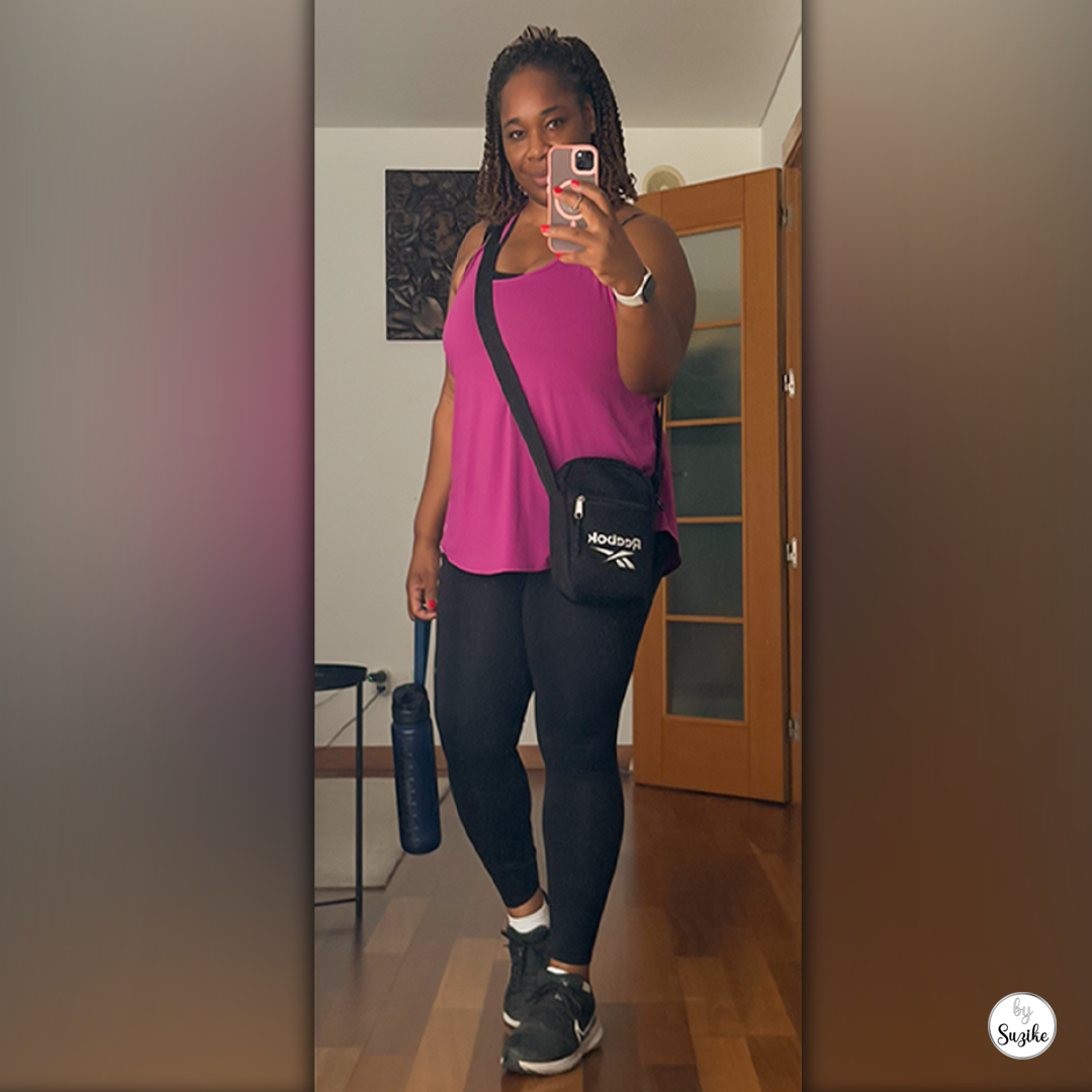 Woman in workout clothes taking a mirror selfie before a 30-minute walk on a low-energy day.