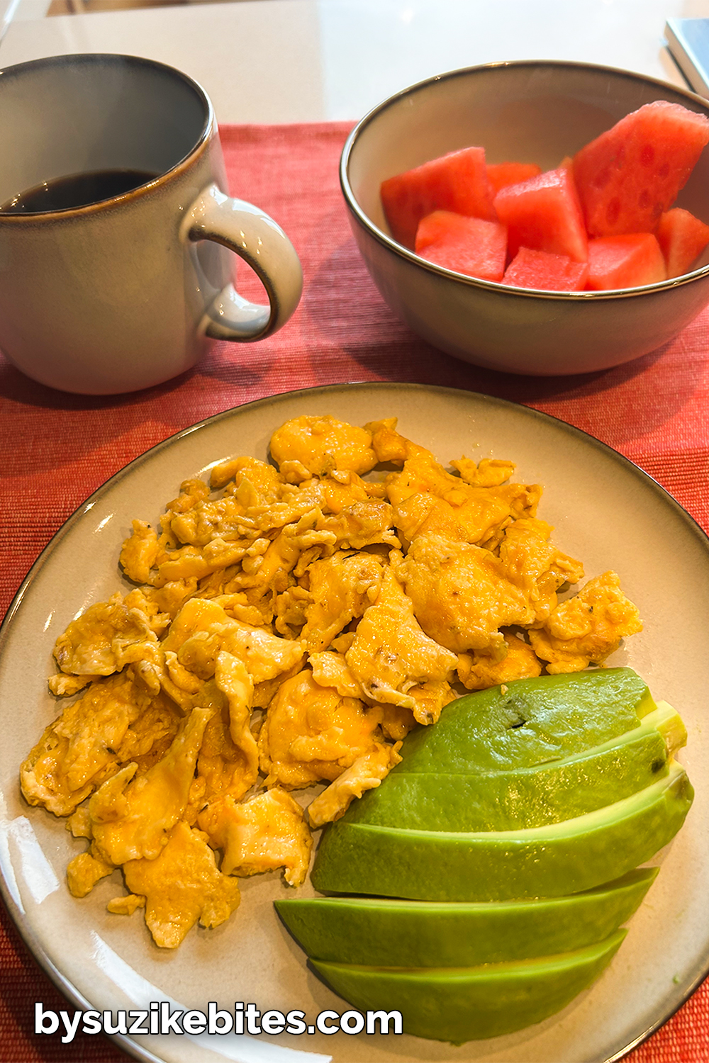 day18-weight-loss-journey-breakfast-eggs-avocado-watermelon Low carb breakfast with scrambled eggs, avocado slices, black coffee, and watermelon — part of my Day 18 weight loss journey on BySuzike Bites.