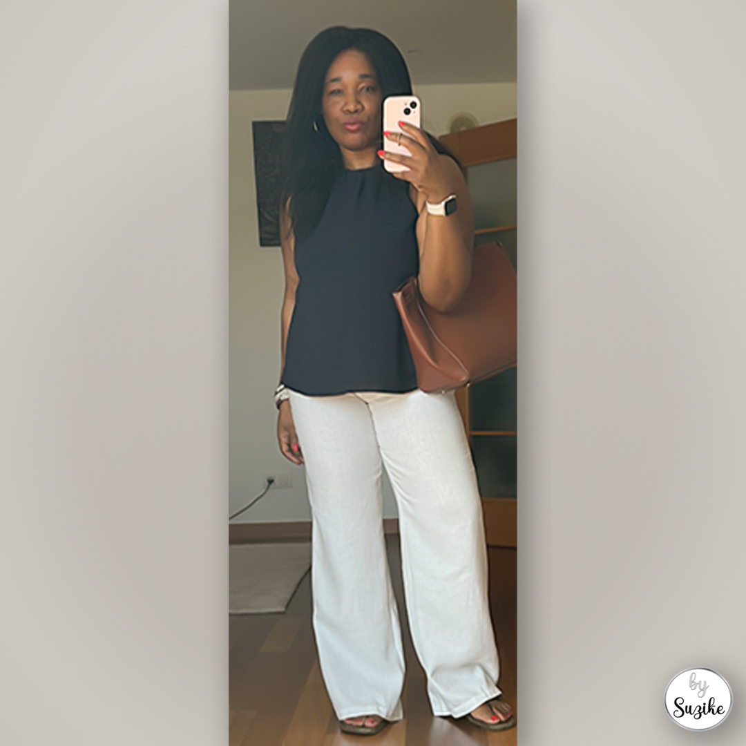 Casual minimalist summer look with black sleeveless top, wide-leg light pants and sandals — real-life outfit mirror photo.