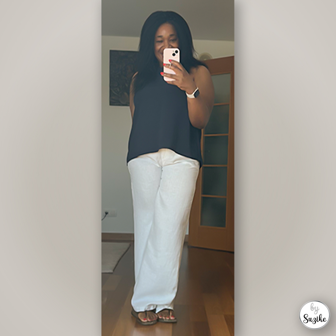 Minimalist black top and loose light pants styled for a casual summer day — simple real-life look.