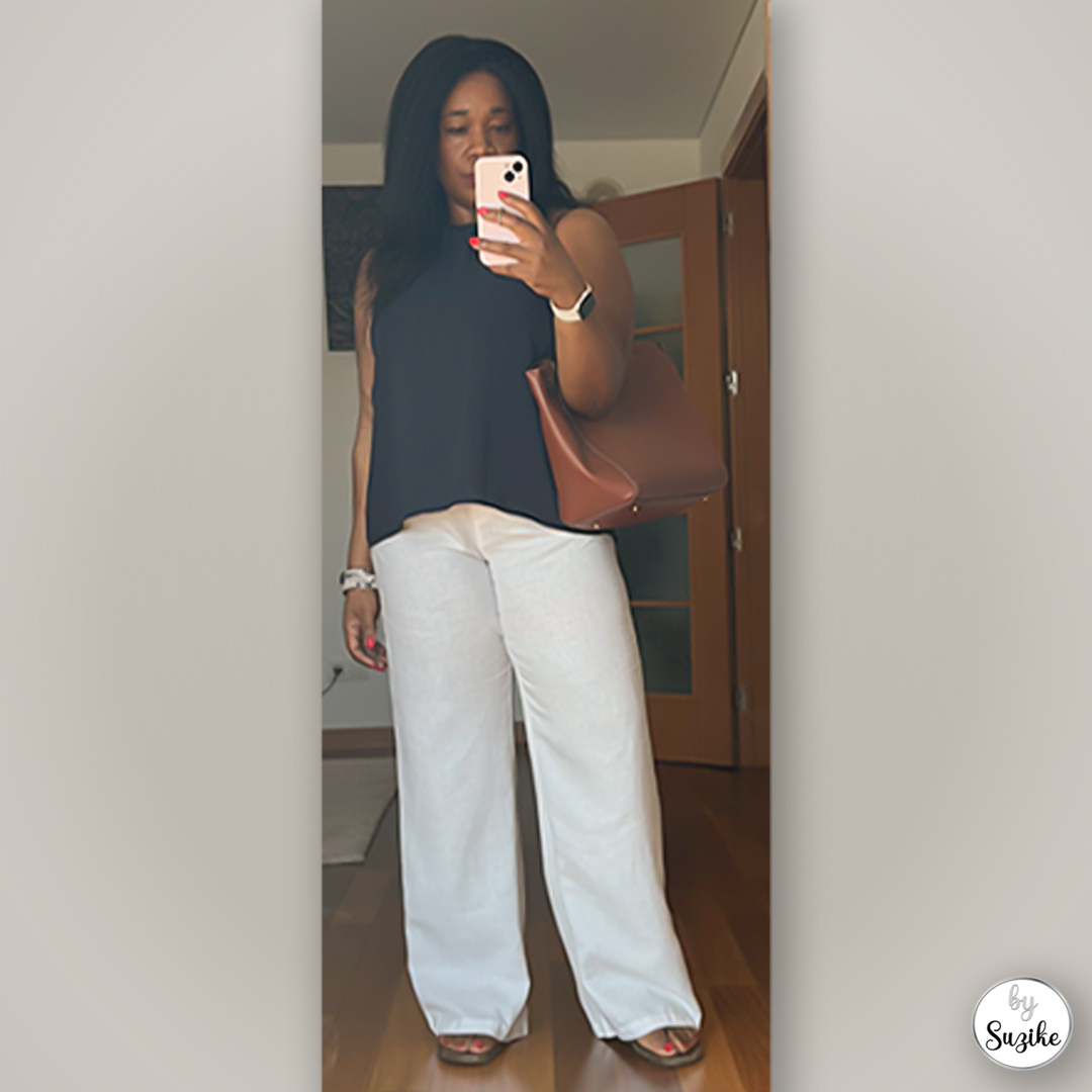 Casual minimalist summer look with brown shoulder bag, black top and wide-leg pants — clean and comfortable outfit.