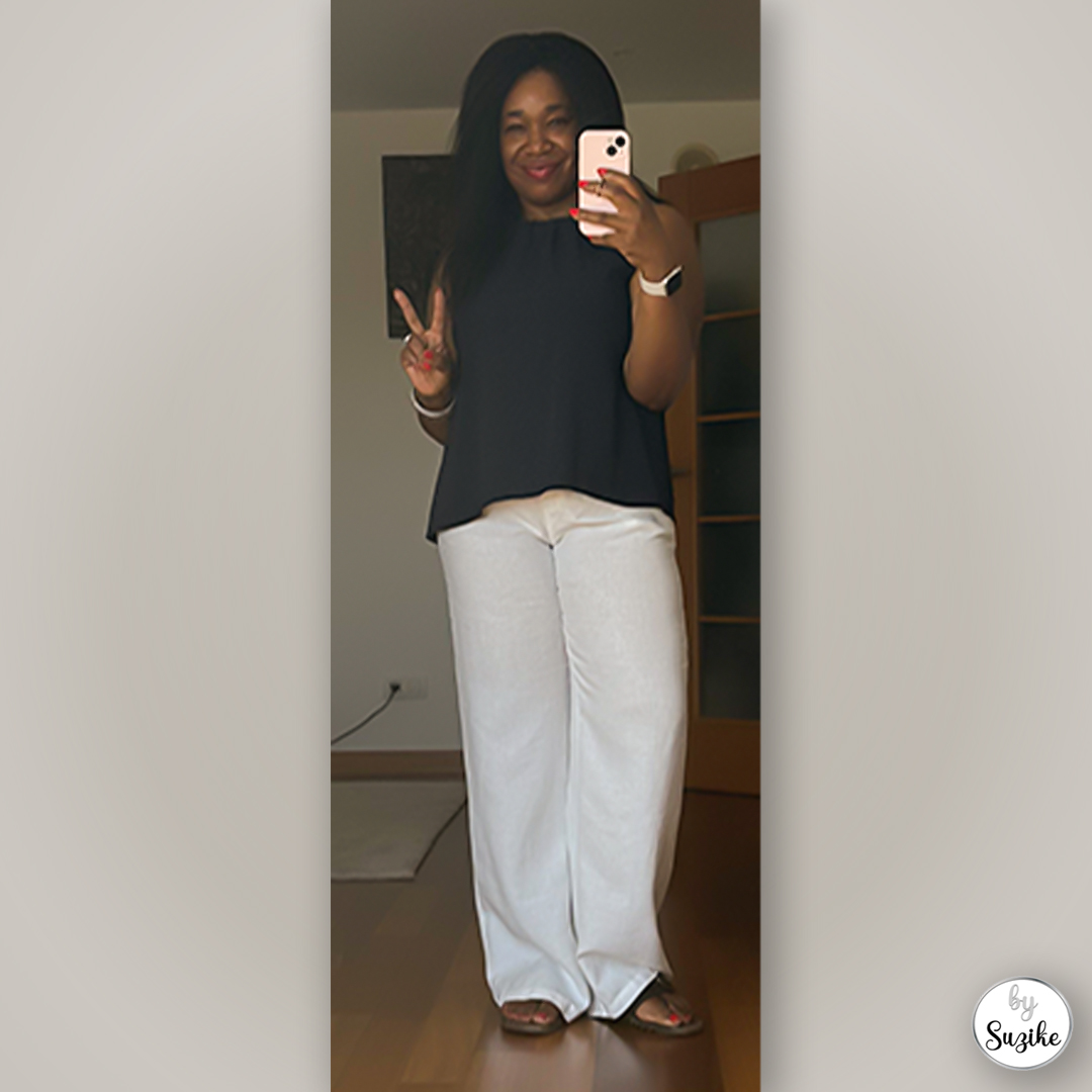 Simple summer outfit with flowy black top and soft light pants, minimalist mirror selfie style.