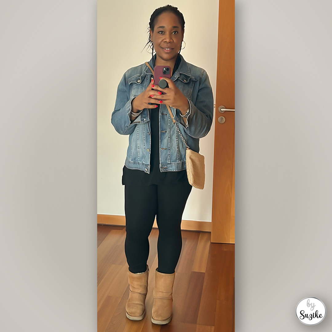Suzike wearing a casual chic shopping outfit with denim jacket, black leggings and beige boots.