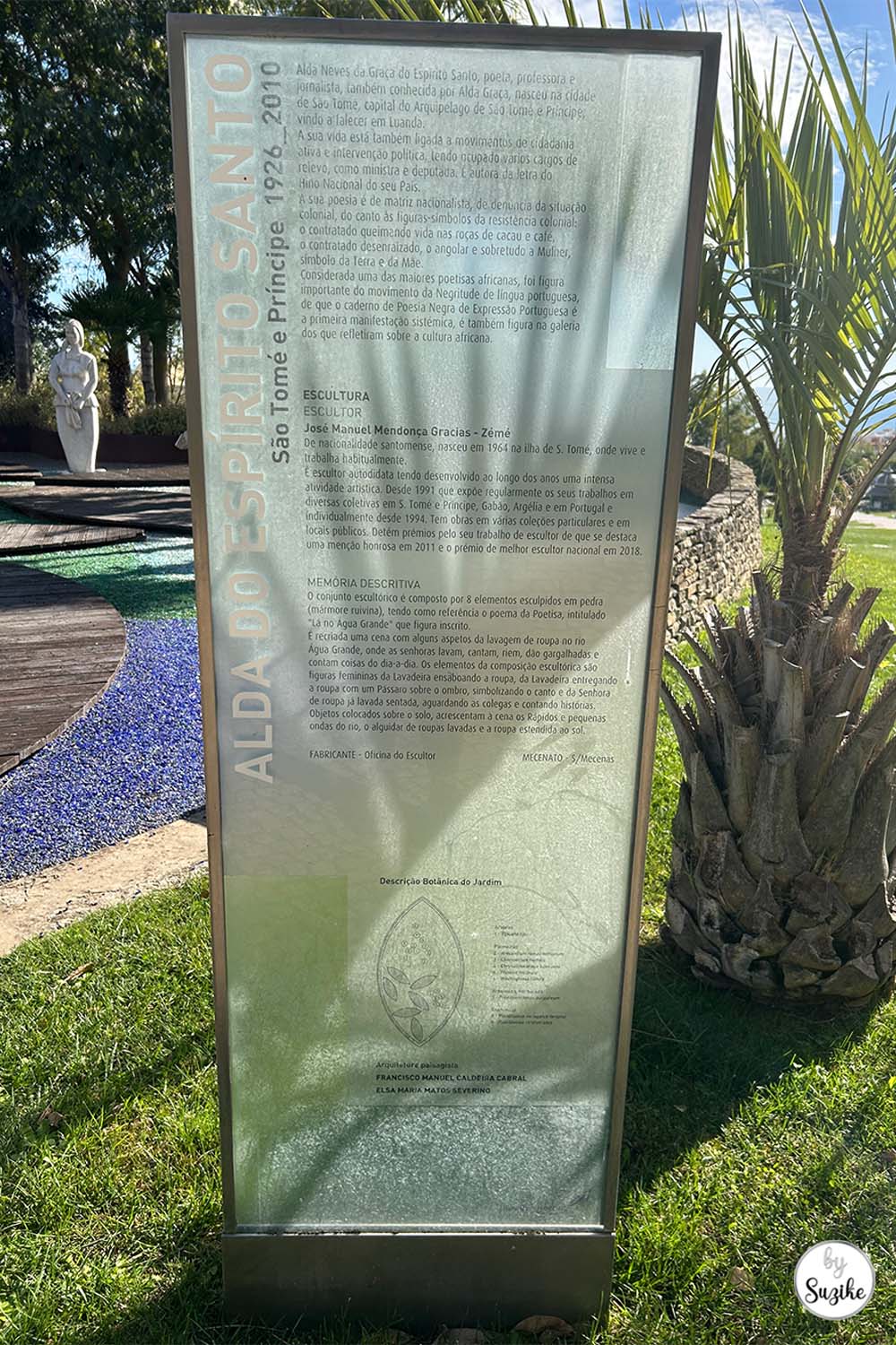 Glass information panel standing in the garden area of the Park of the Poets in Oeiras