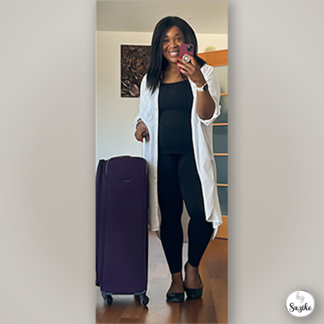 woman wearing the best travel outfit for women with a large purple Samsonite suitcase, ideal for airport travel