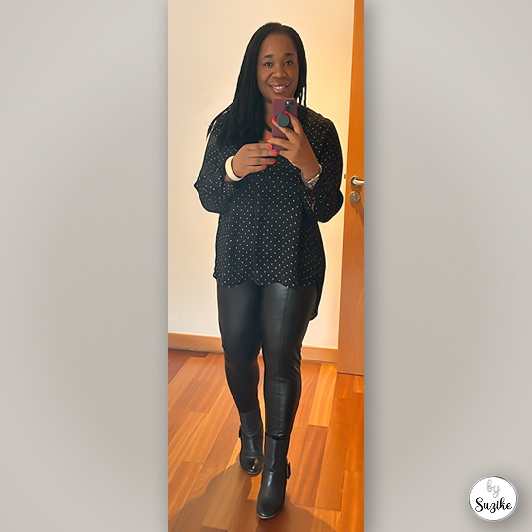 Full-body mirror photo of Suzike styling a black top with leather leggings and Fly London boots