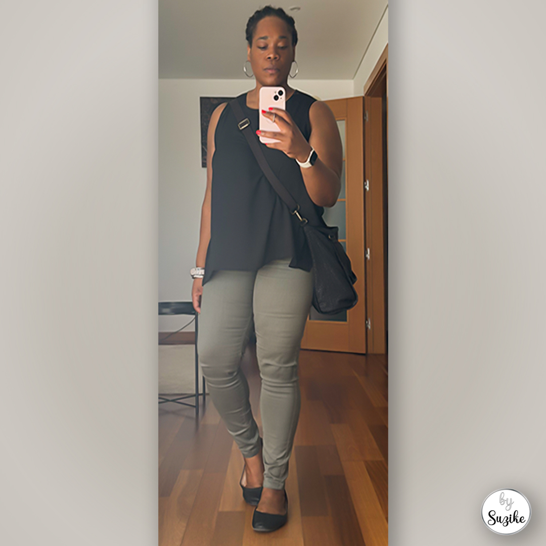 Black top and green pants everyday look captured in a mirror