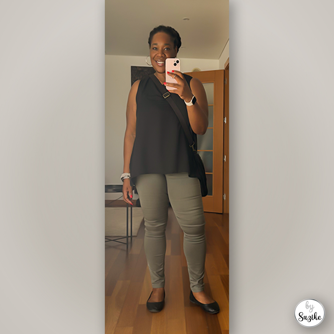 Casual black sleeveless top with green pants outfit, mirror photo