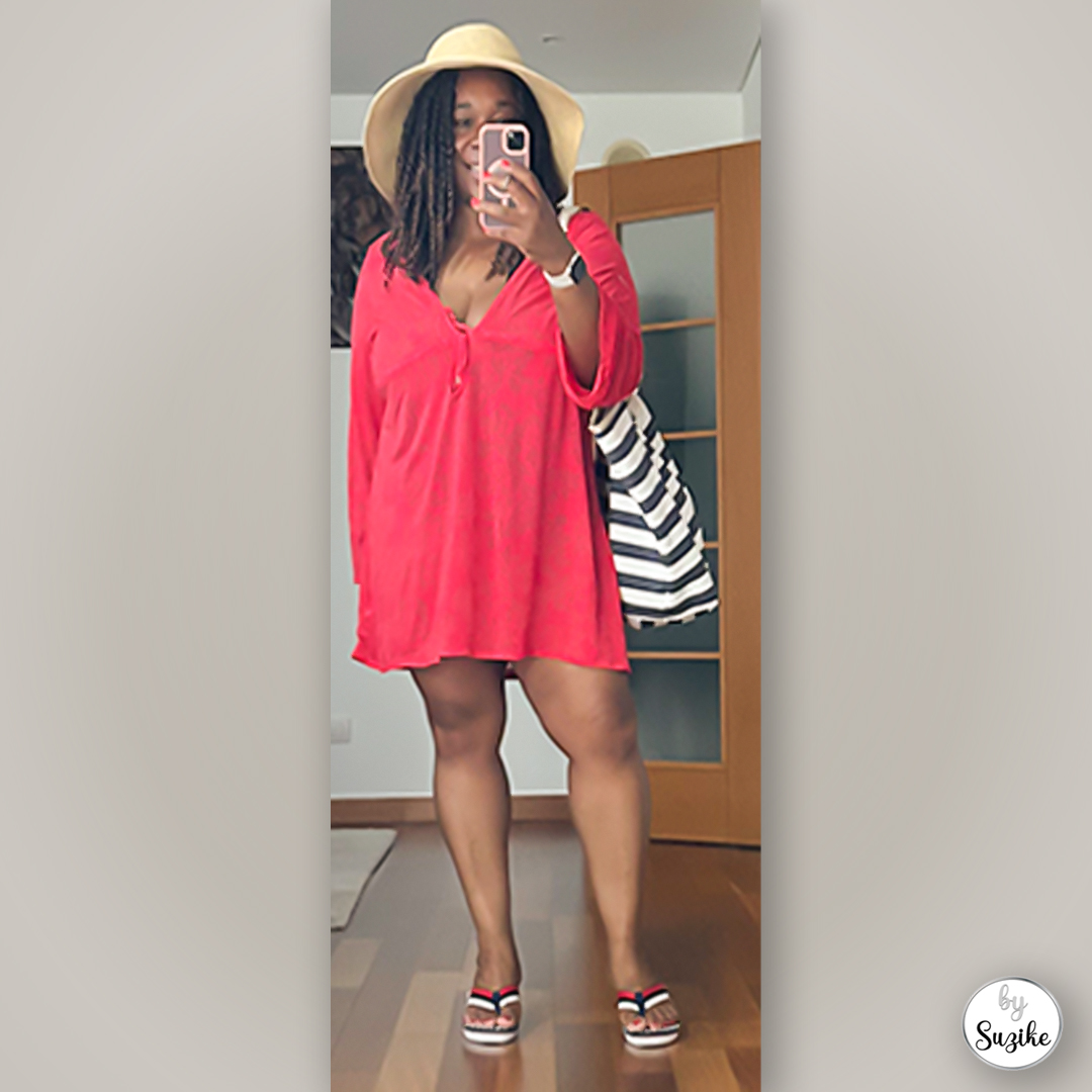 Full-body mirror selfie of Suzike in a red summer dress holding a striped tote bag, simple and comfortable summer outfit idea.