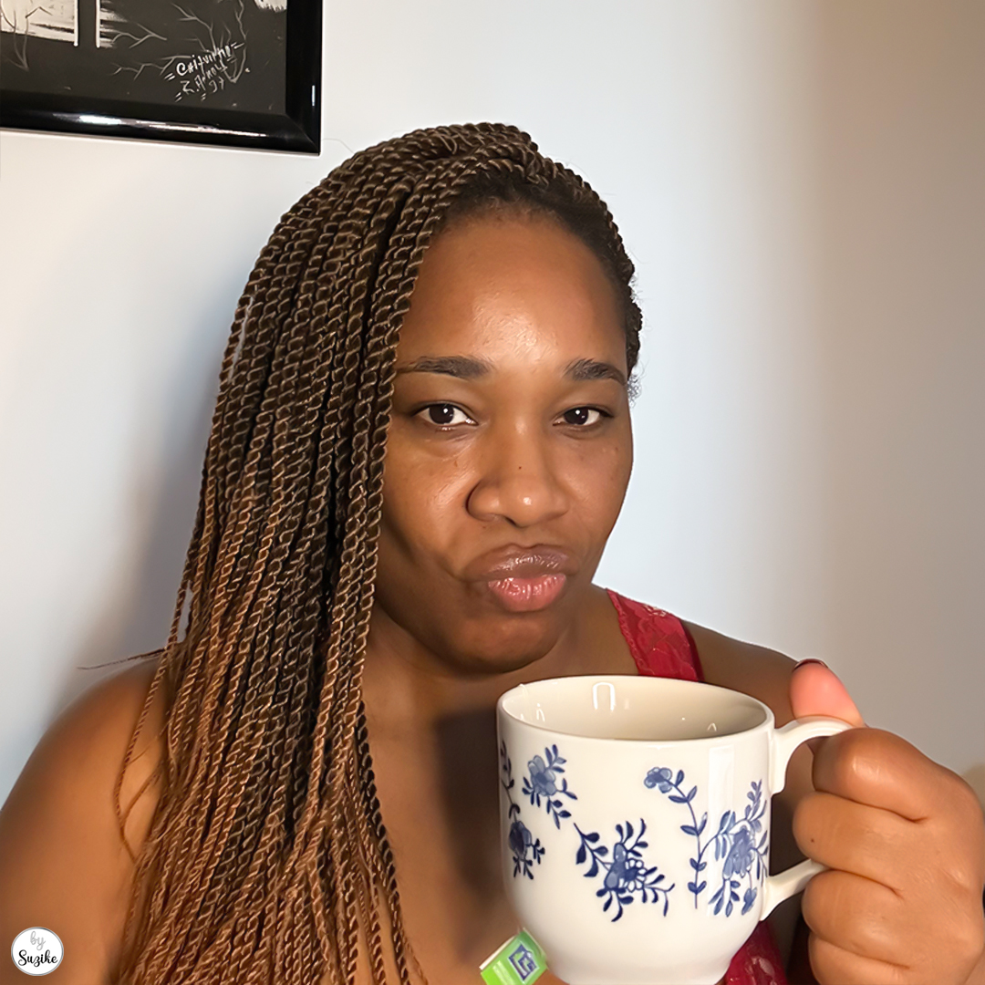 Woman drinking tea while sitting at home, taking a moment for herself during the holiday season