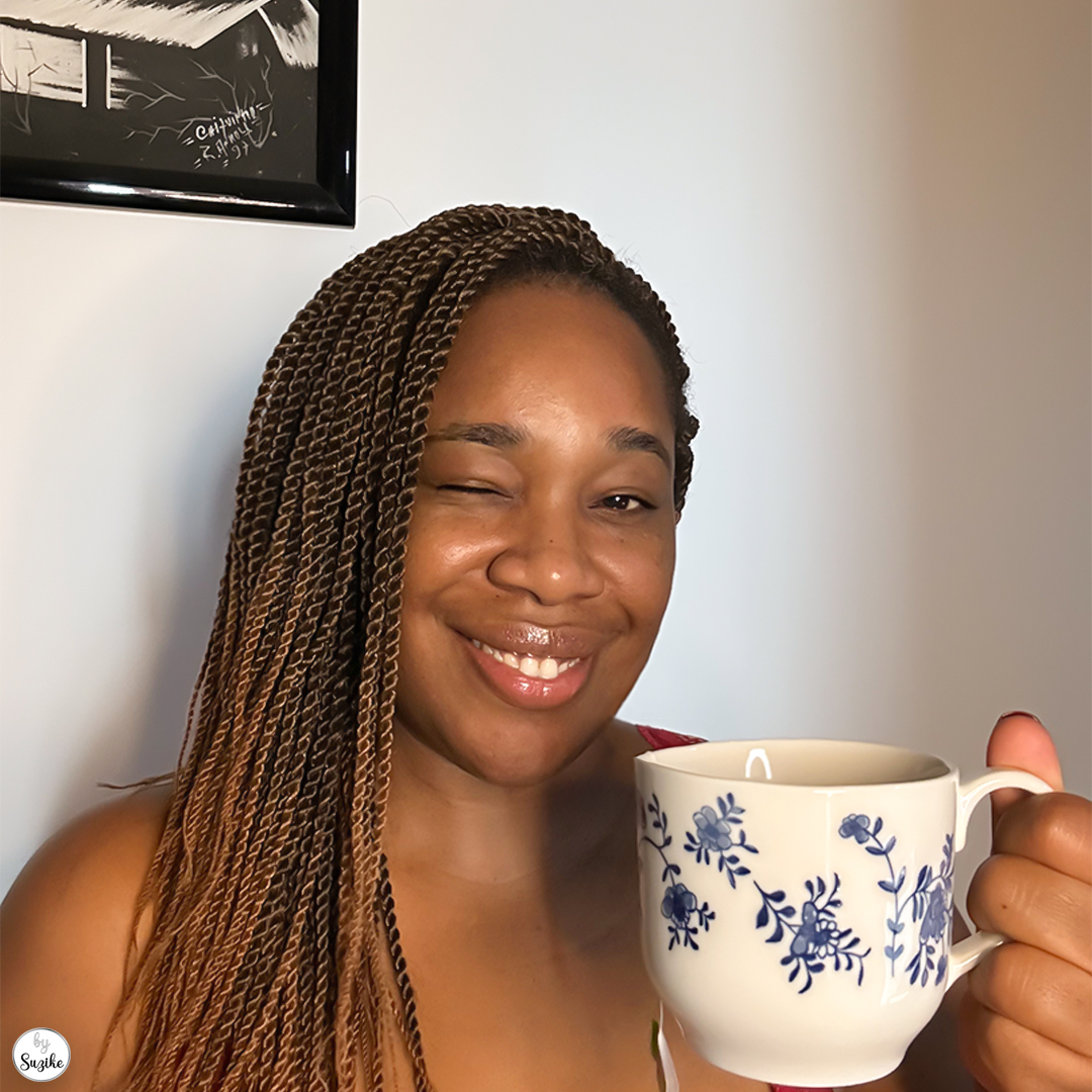 Woman winking and holding a mug, expressing lighthearted self-care during the holiday season