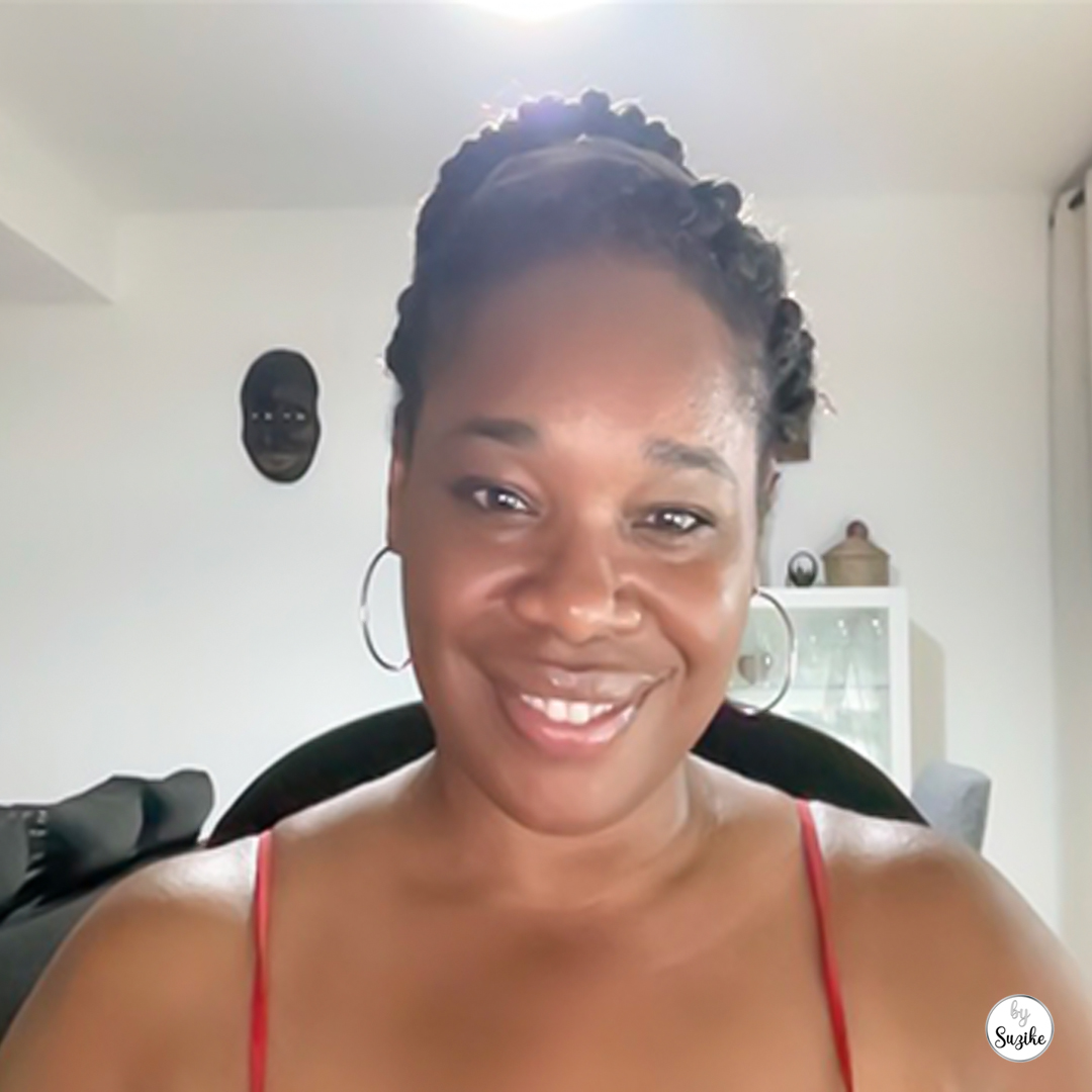 Suzike smiling while sitting at her desk, used to illustrate real-life women experiencing fatigue after 40. Women’s Health