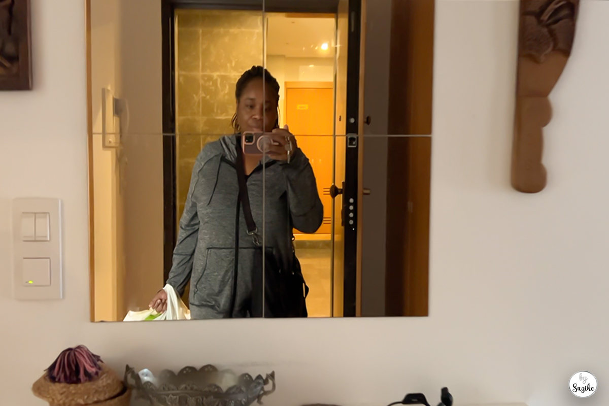 Suzike arriving home after a quick grocery run, holding a shopping bag and capturing the moment in the mirror. Life Tips & Everyday Wisdom category on By Suzike