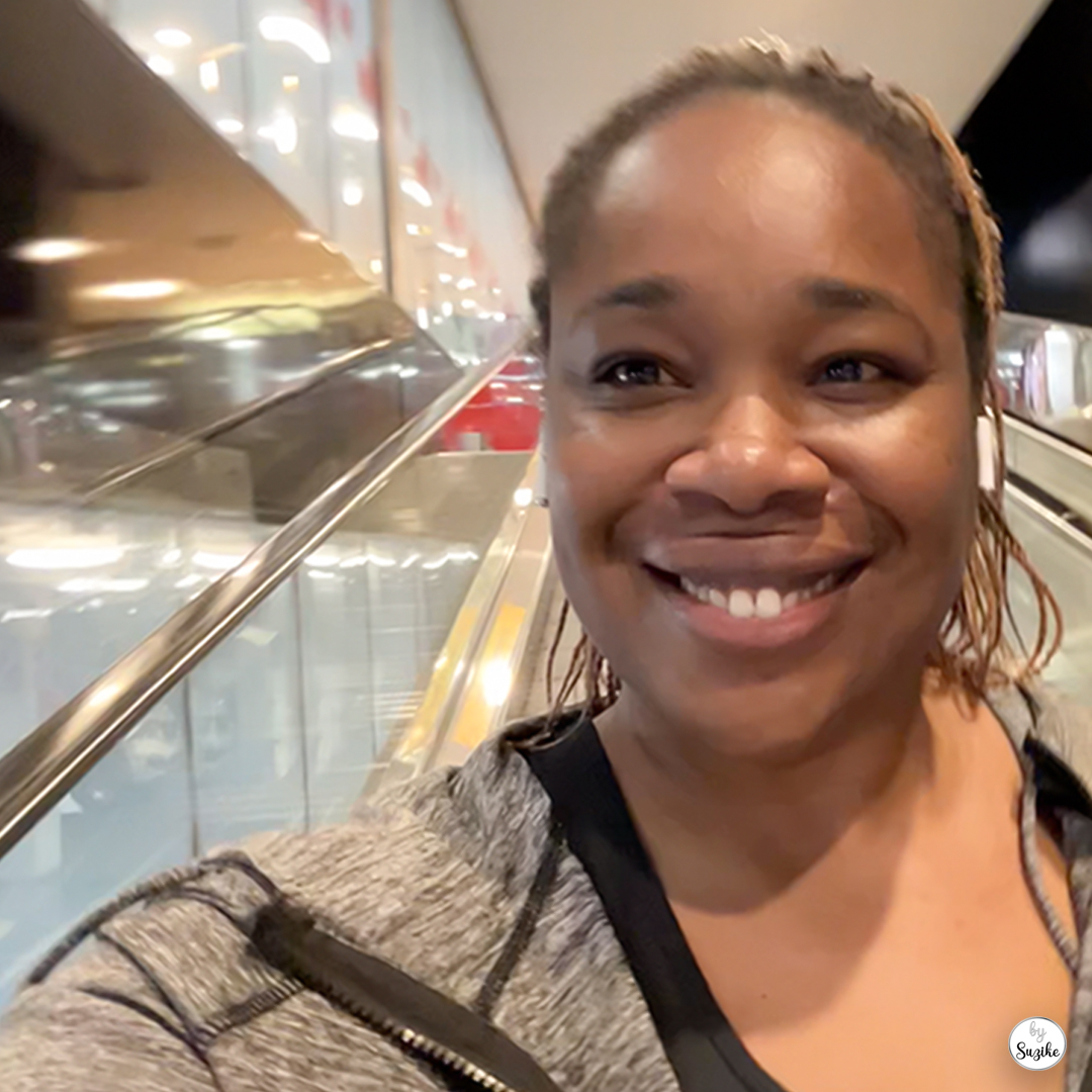 Suzike riding the escalator on her quick grocery run