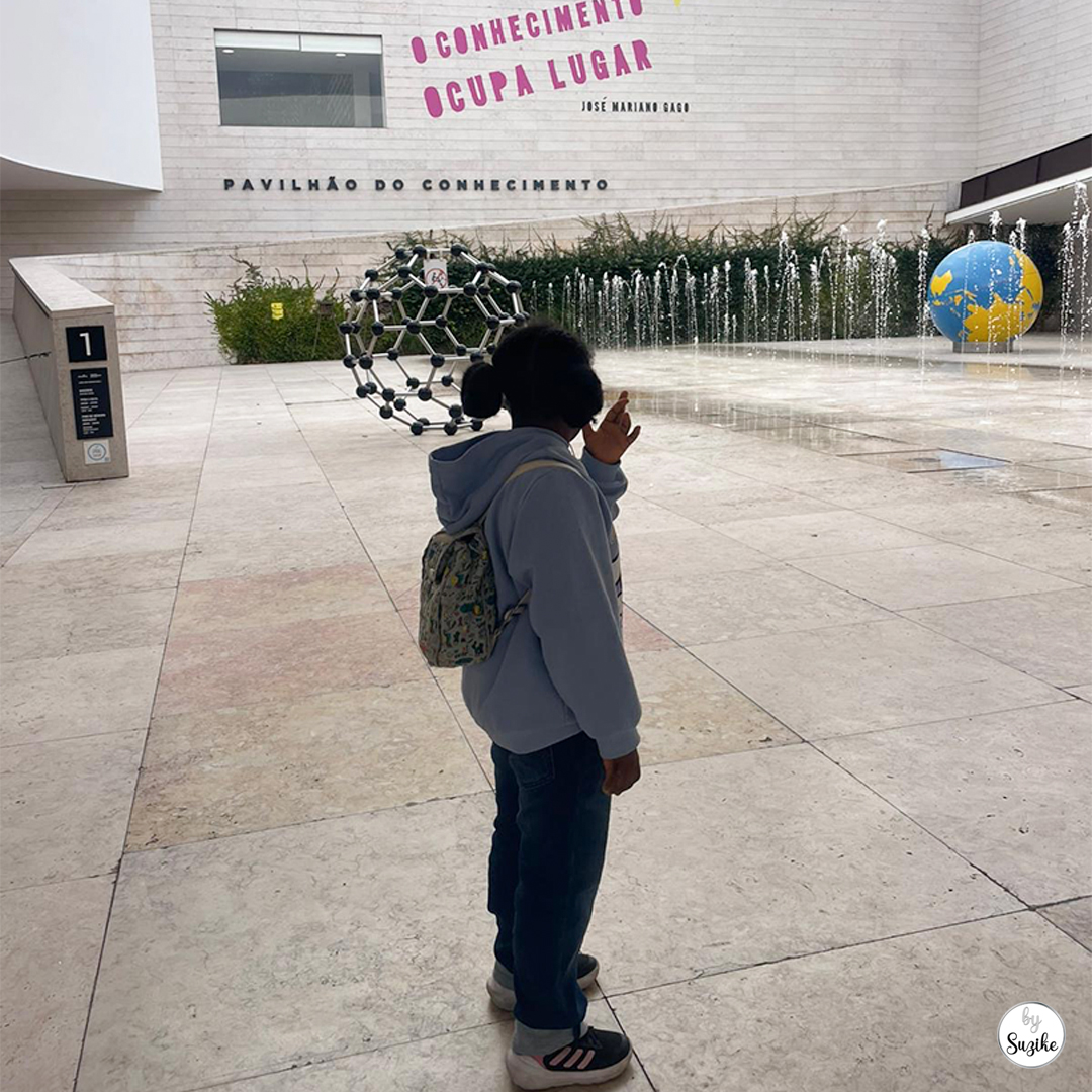 Child standing outside Pavilhao do Conhecimento in Lisbon before entering the museum