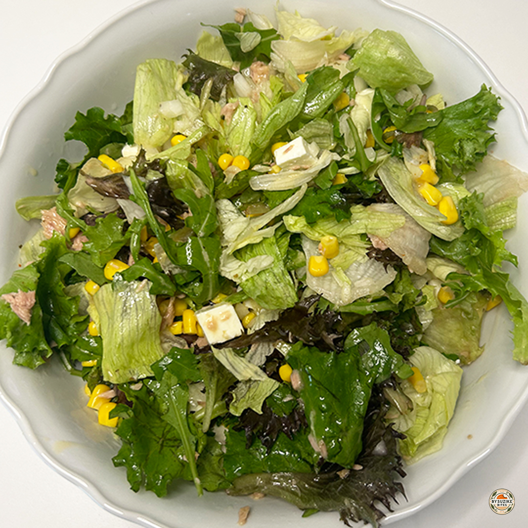 10-minute feta and tuna salad in a bowl with lettuce, corn, onion, and oregano vinaigrette
