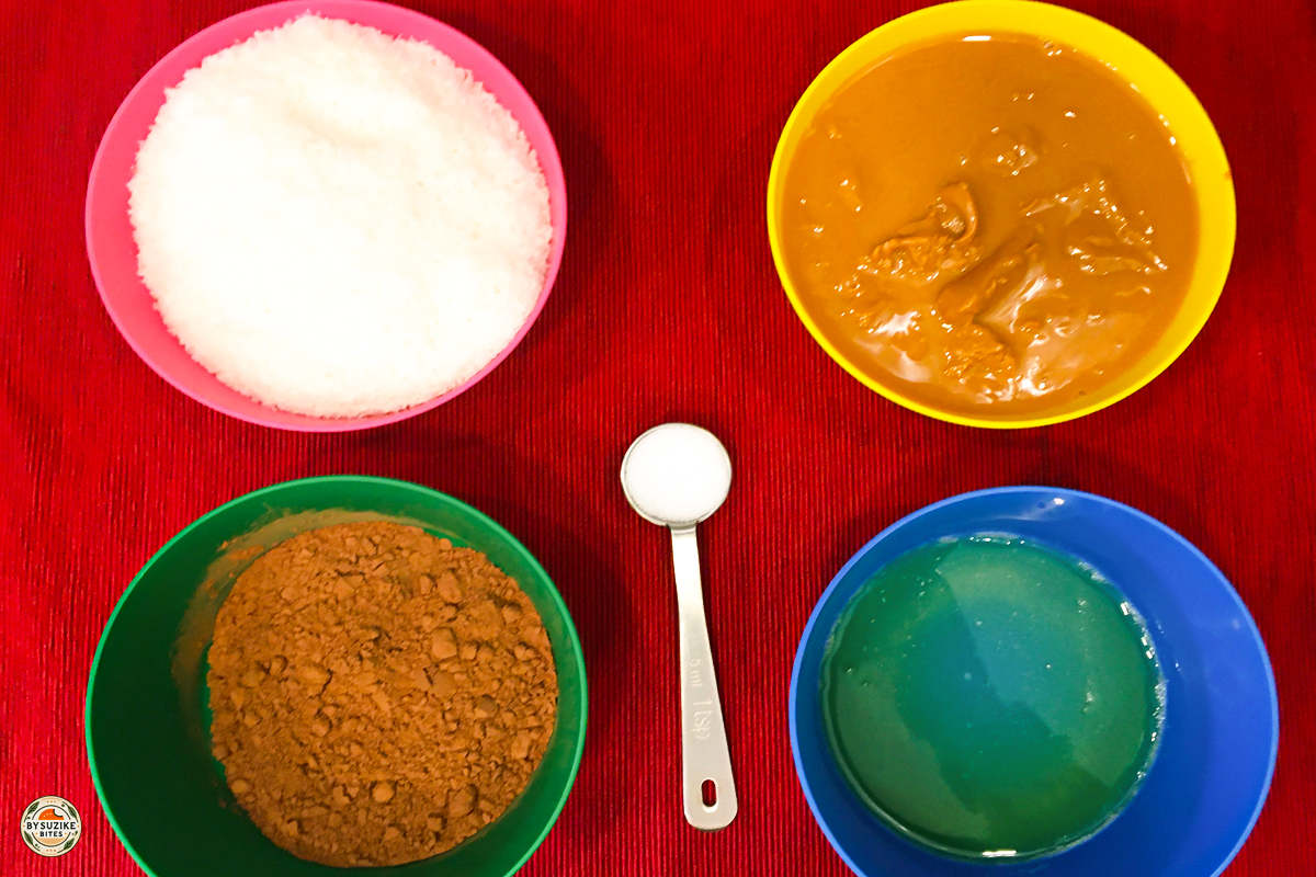 Ingredients for keto no bake cookies arranged in bowls on a red background