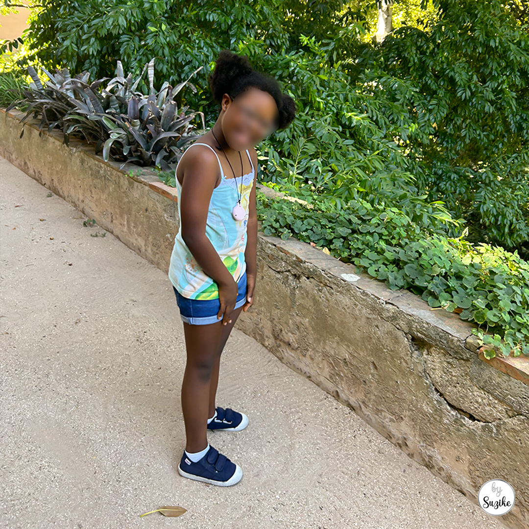 Felisberta standing on a shaded path next to greenery at Monteiro Mor Park and Theatre Museum.