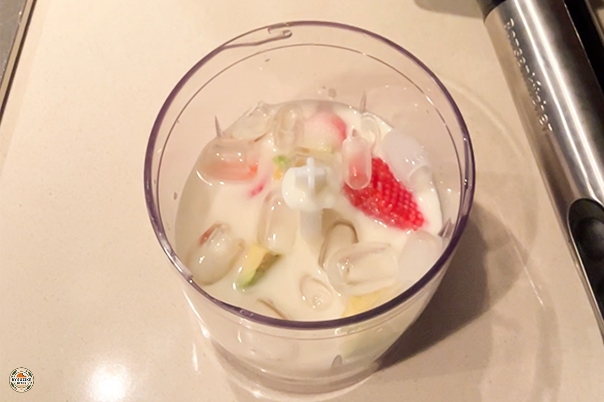 Glass of low carb strawberry avocado smoothie with a slice of strawberry on top