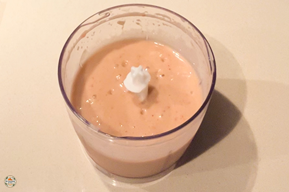 Glass of low carb strawberry avocado smoothie with a slice of strawberry on top