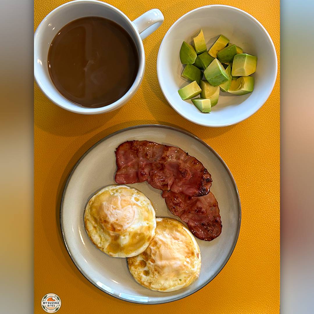Two fried eggs with bacon and avocado, a simple low carb breakfast idea.