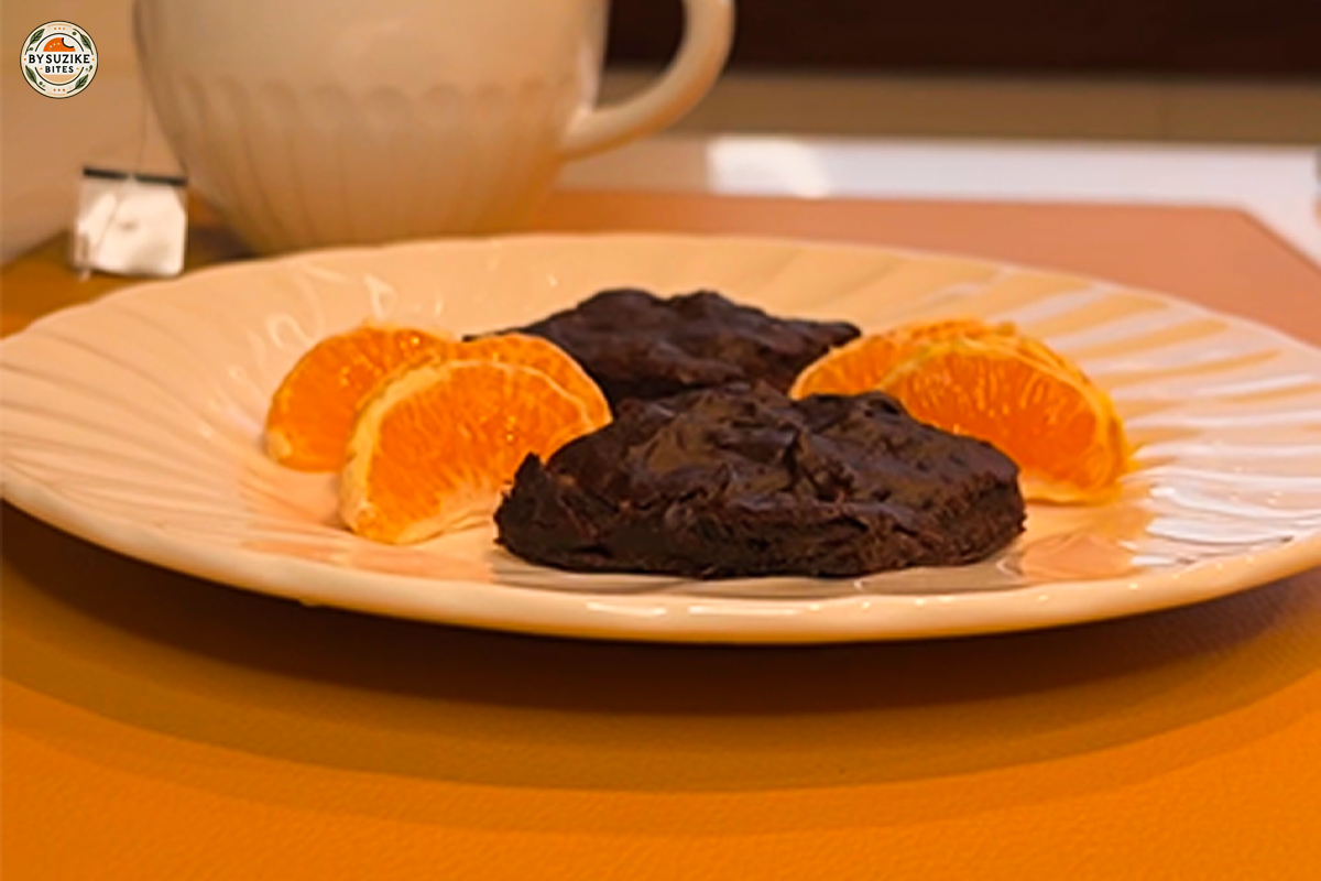 Banana brownies on a plate with orange slices.