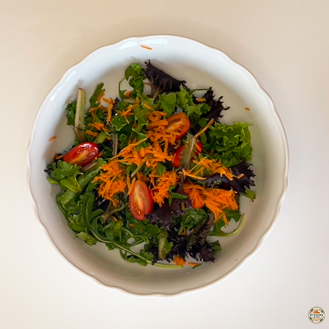 Egg salad with feta and mozzarella with shredded carrot added over mixed greens and cherry tomatoes.