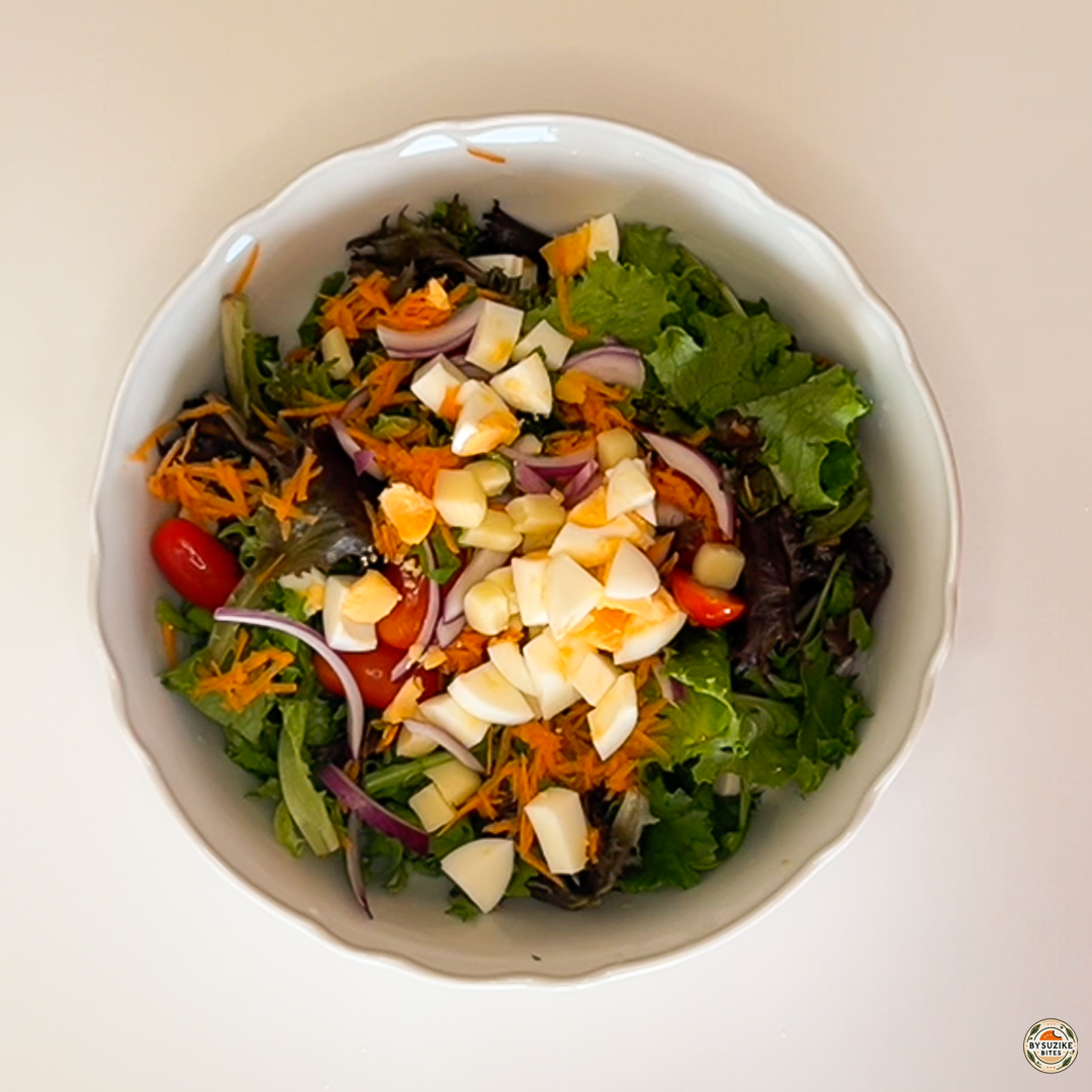 Egg salad with feta and mozzarella with chopped boiled egg added on top before dressing.