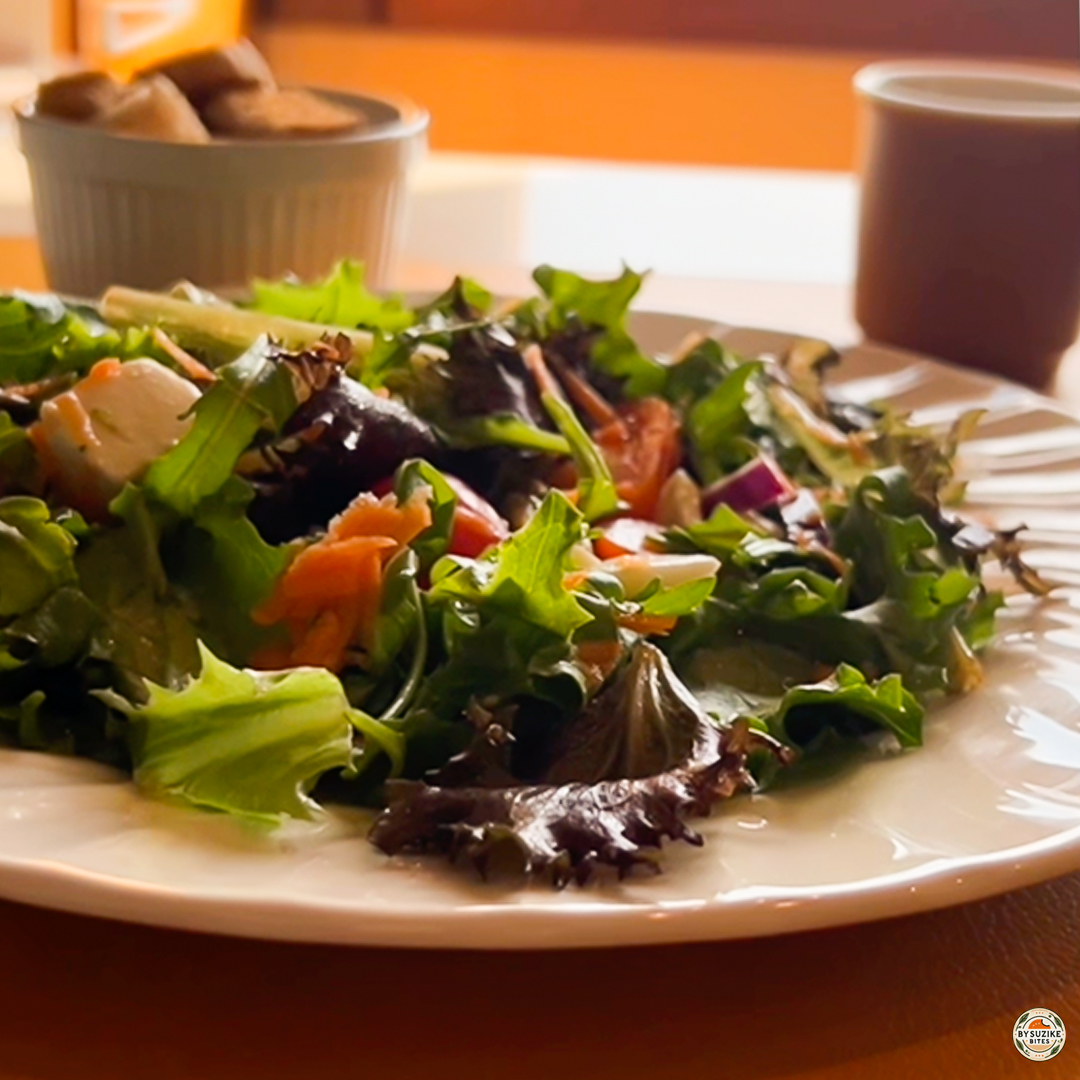 Egg salad with feta and mozzarella served as a healthy lunch, plated and ready to eat with coffee.