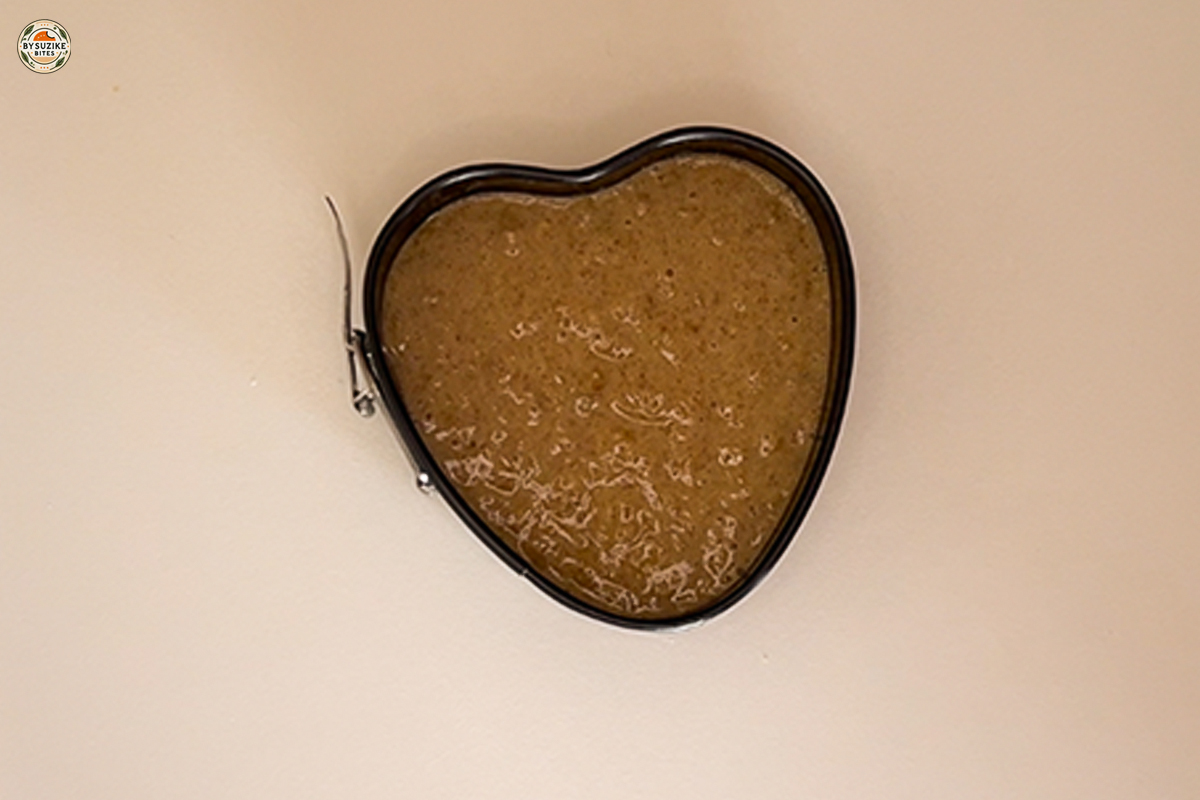 Fluffy banana oat cake batter poured into a heart shaped mold.