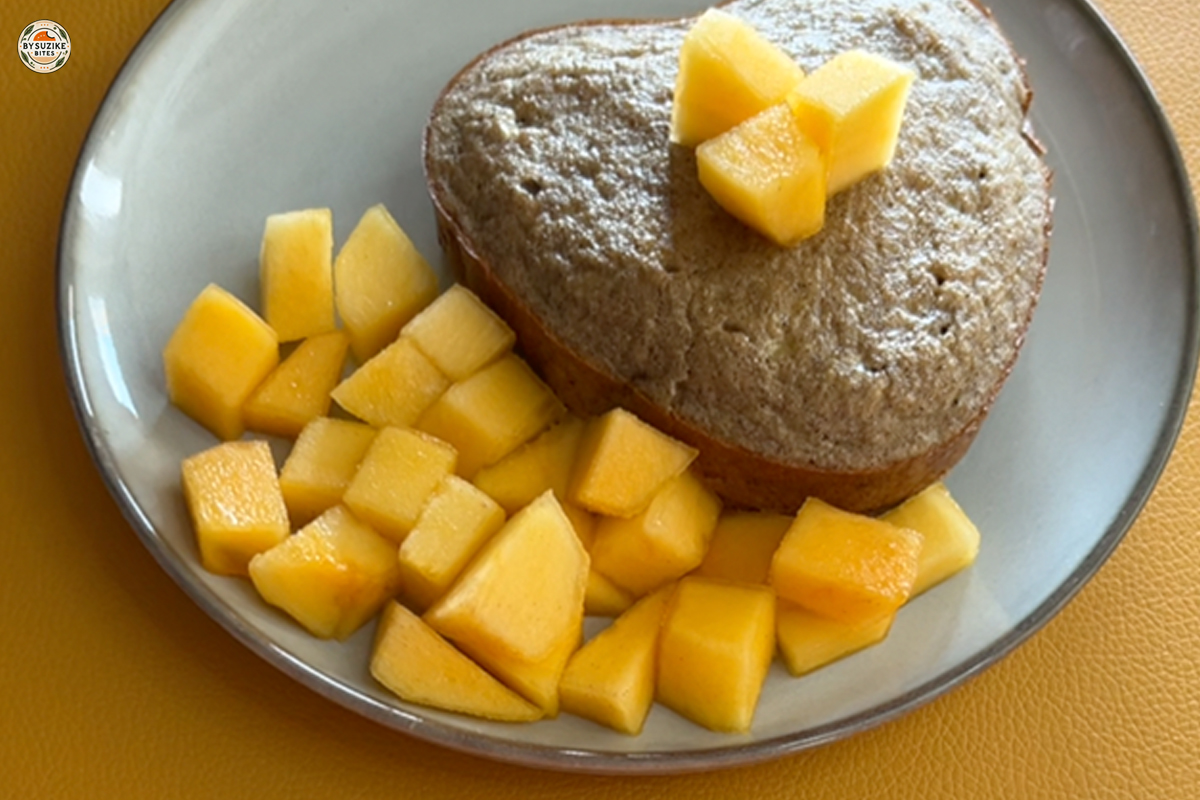 Fluffy banana oat cake served with fresh mango for breakfast