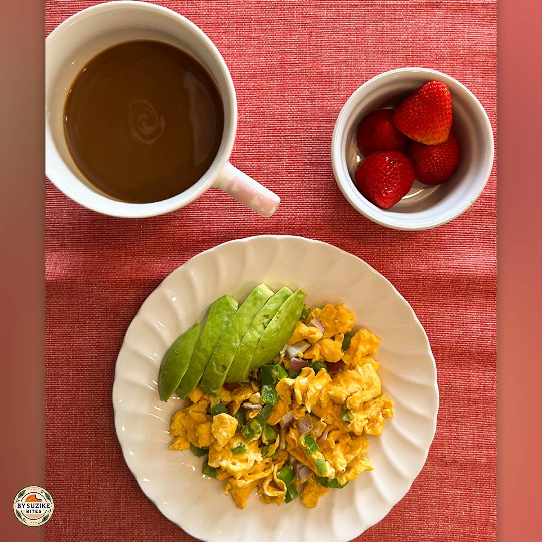 Low carb breakfast idea with scrambled eggs, green bell pepper, red onion and avocado, served with espresso.