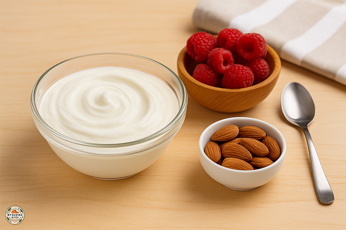 Greek yogurt low carb snack idea with raspberries and almonds for extra protein and satiety.