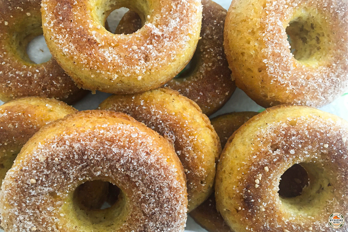 Finished keto cinnamon donuts with cinnamon coating on a plate