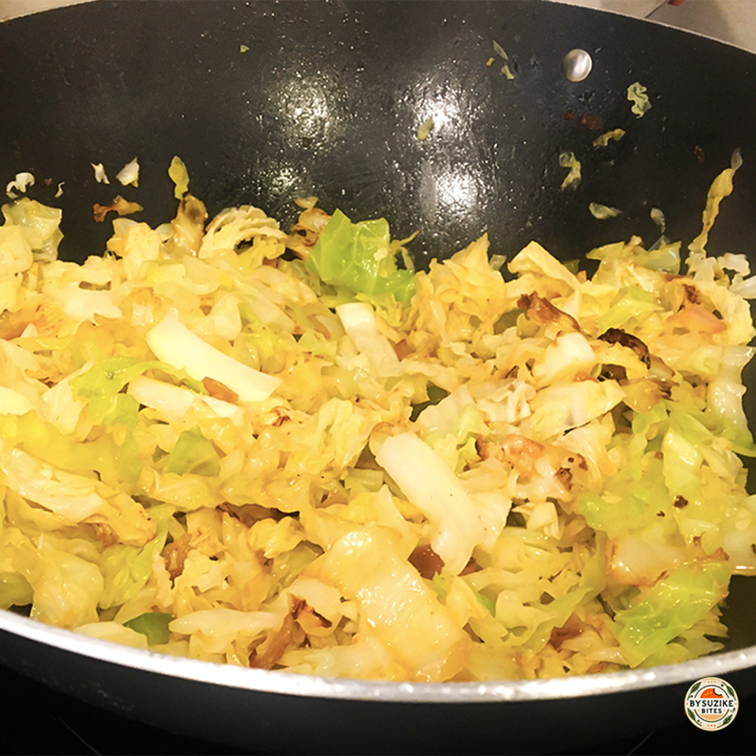 Keto fried cabbage recipe cooked in a wok with butter and red onion, easy low carb side dish.