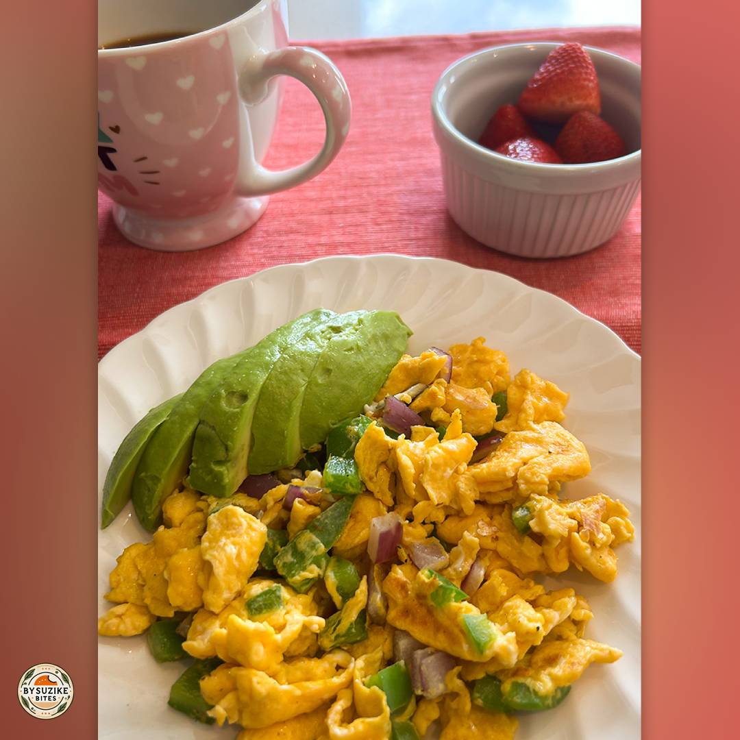 Low carb breakfast idea with scrambled eggs, green bell pepper, red onion and avocado, served with espresso.