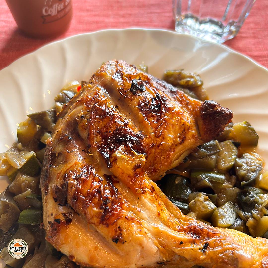 Low carb meal idea with roasted chicken leg served over sautéed zucchini and eggplant.